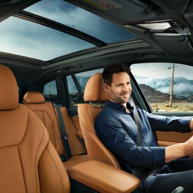 BMW X3 M40i, cockpit with man at the wheel BMW X3 M40i, cockpit with man at the wheel