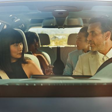 BMW Gesture Control Man and woman are sitting in the car, woman is applying the gesture control