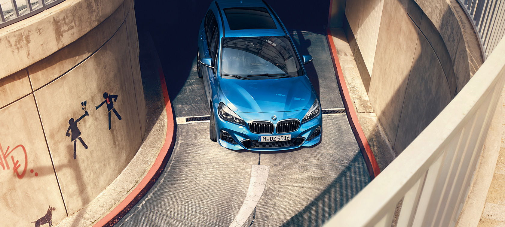 BMW 2 Series Gran Tourer driving in multi-storey car park BMW 2 Series Gran Tourer F46 Estoril Blue metallic bird’s-eye view driving in multi-storey car park