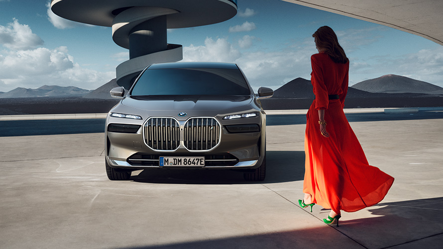 BMW i7 Sedan front view with model in urban landscape  
