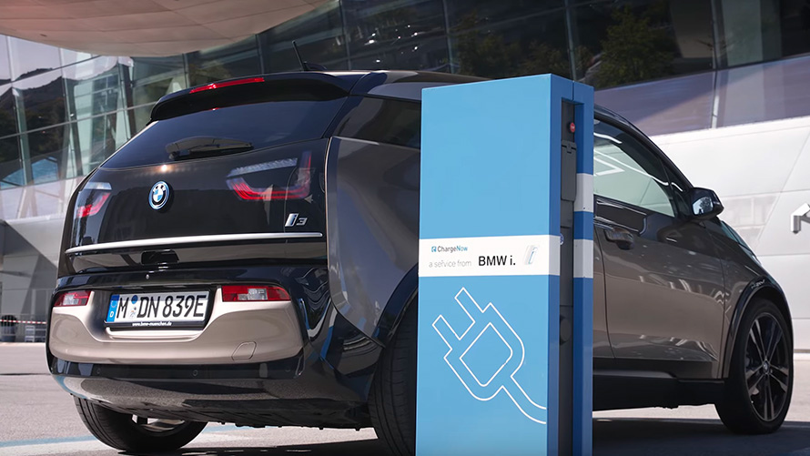 BMW i3 on charging station  BMW i3 on charging station three-quarter rear view