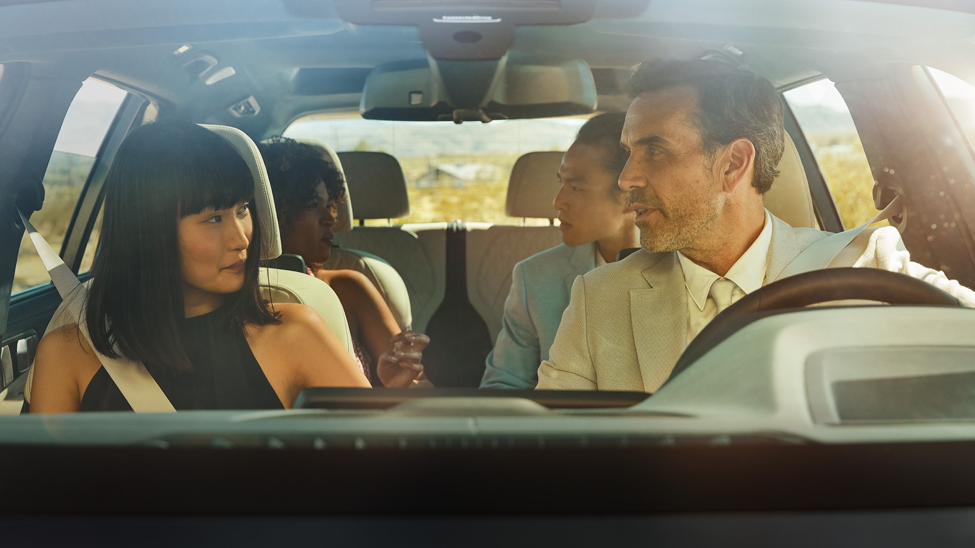 BMW Gesture Control Man and woman are sitting in the car, woman is applying the gesture control